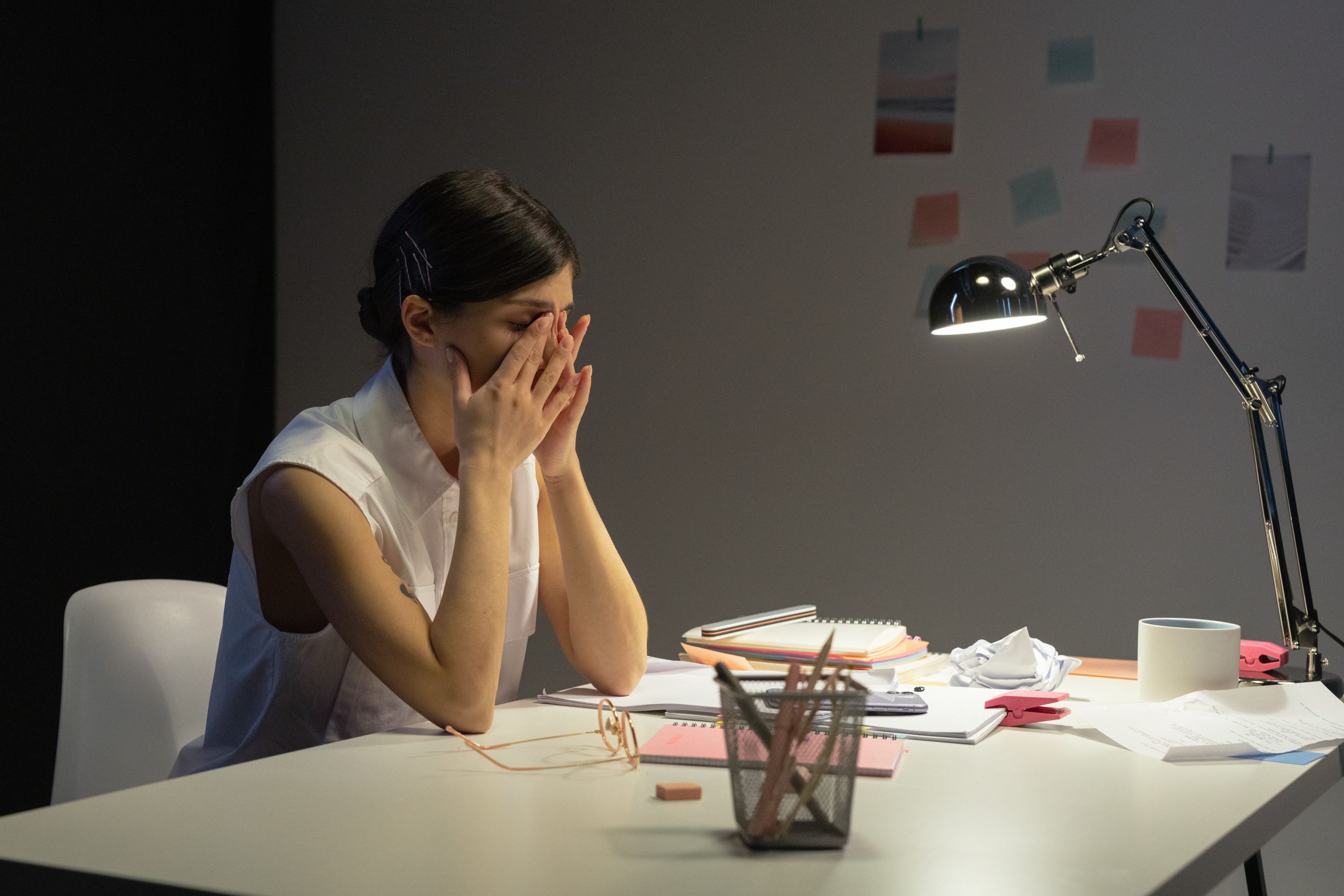 Adult feeling overwhelmed by tasks and responsibilities at a desk